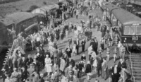 Crowds of people between displays of railway vehicles at Noel Park Good Yard