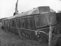 DMU in field with crane behind