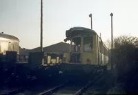 Derby class 116 Suburban car SC50874 was withdrawn following a sidelong collision with a Class 303. It is seen at Hamilton Depot following stripping of reusable parts on 26th November 1977. On the left is a partly cut-up Mark 1 coach and a Class 116 centre car.