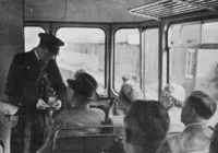 Guard issuing tickets on board railbus